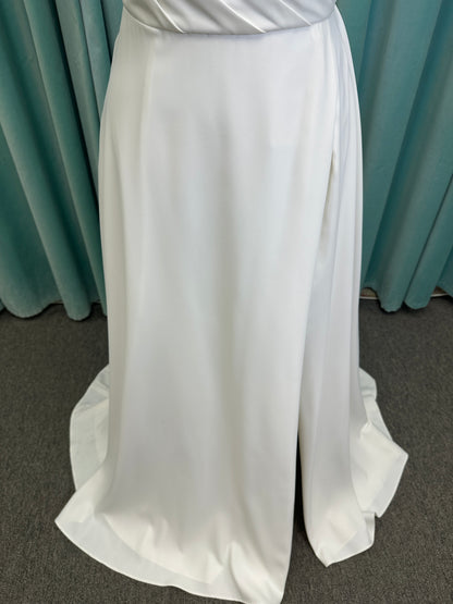 Essense of Australia D4225 ivory satin A-line wedding dress on mannequin with strapless scoop neckline, ruched bodice, and a front slit in the skirt.
