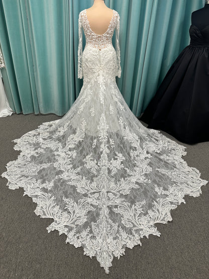 Essense of Australia D4213 lace fit-and-flare wedding dress with plunging neckline and sheer lace sleeves featuring a long lace train