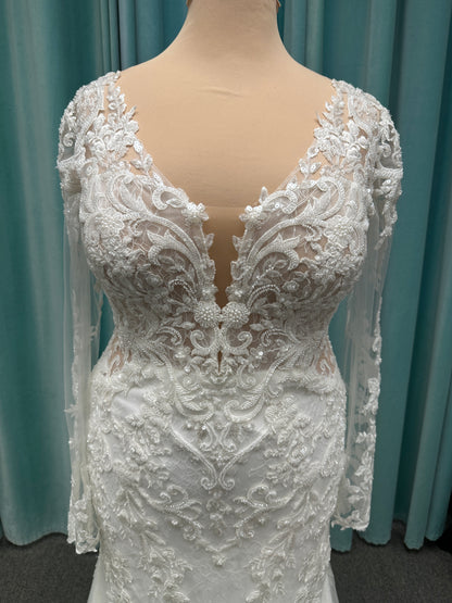 Essense of Australia D4213 lace fit-and-flare wedding dress with plunging neckline and sheer lace sleeves featuring a long lace train