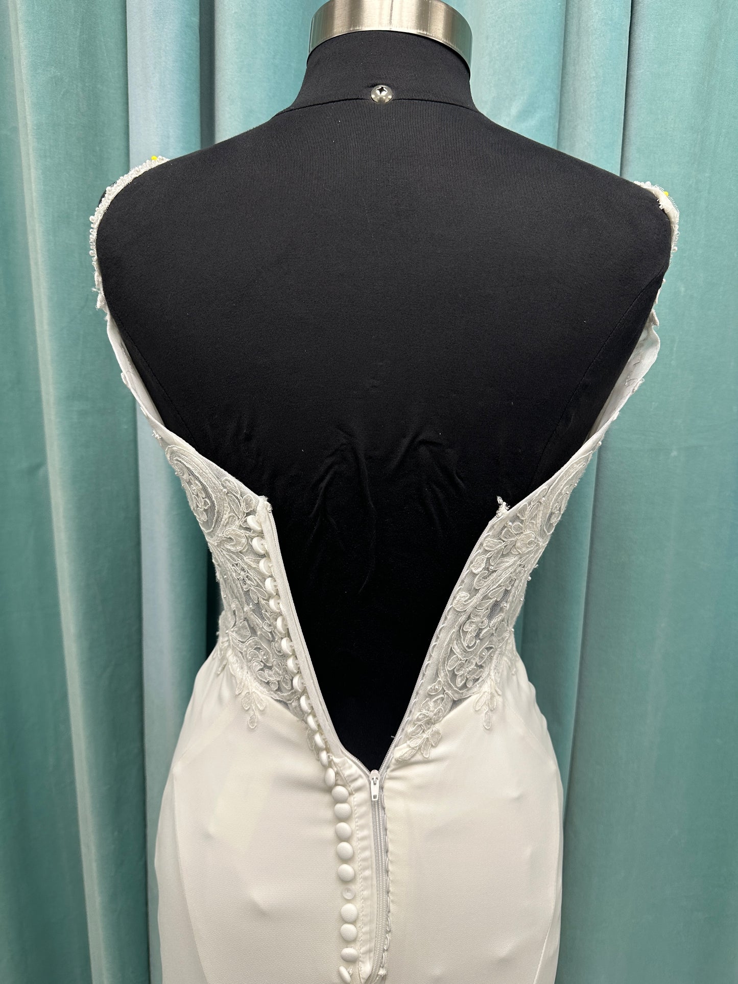 Essense of Australia D4181 column wedding dress with plunging V-neckline, pearl straps, lace bodice, and sleek crepe skirt with lace train