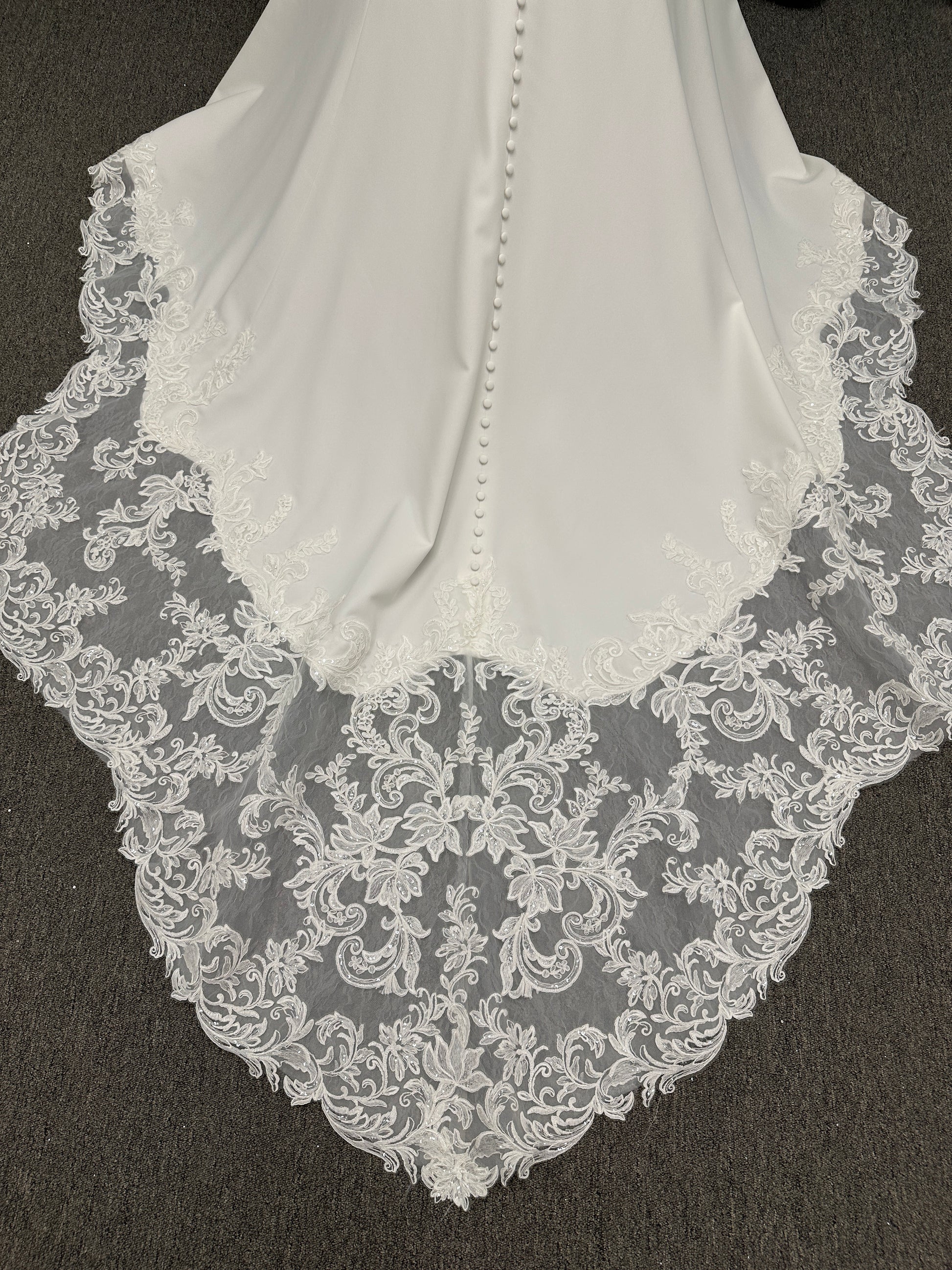 Essense of Australia D4181 column wedding dress with plunging V-neckline, pearl straps, lace bodice, and sleek crepe skirt with lace train