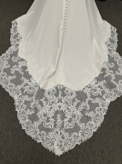 Essense of Australia D4181 column wedding dress with plunging V-neckline, pearl straps, lace bodice, and sleek crepe skirt with lace train
