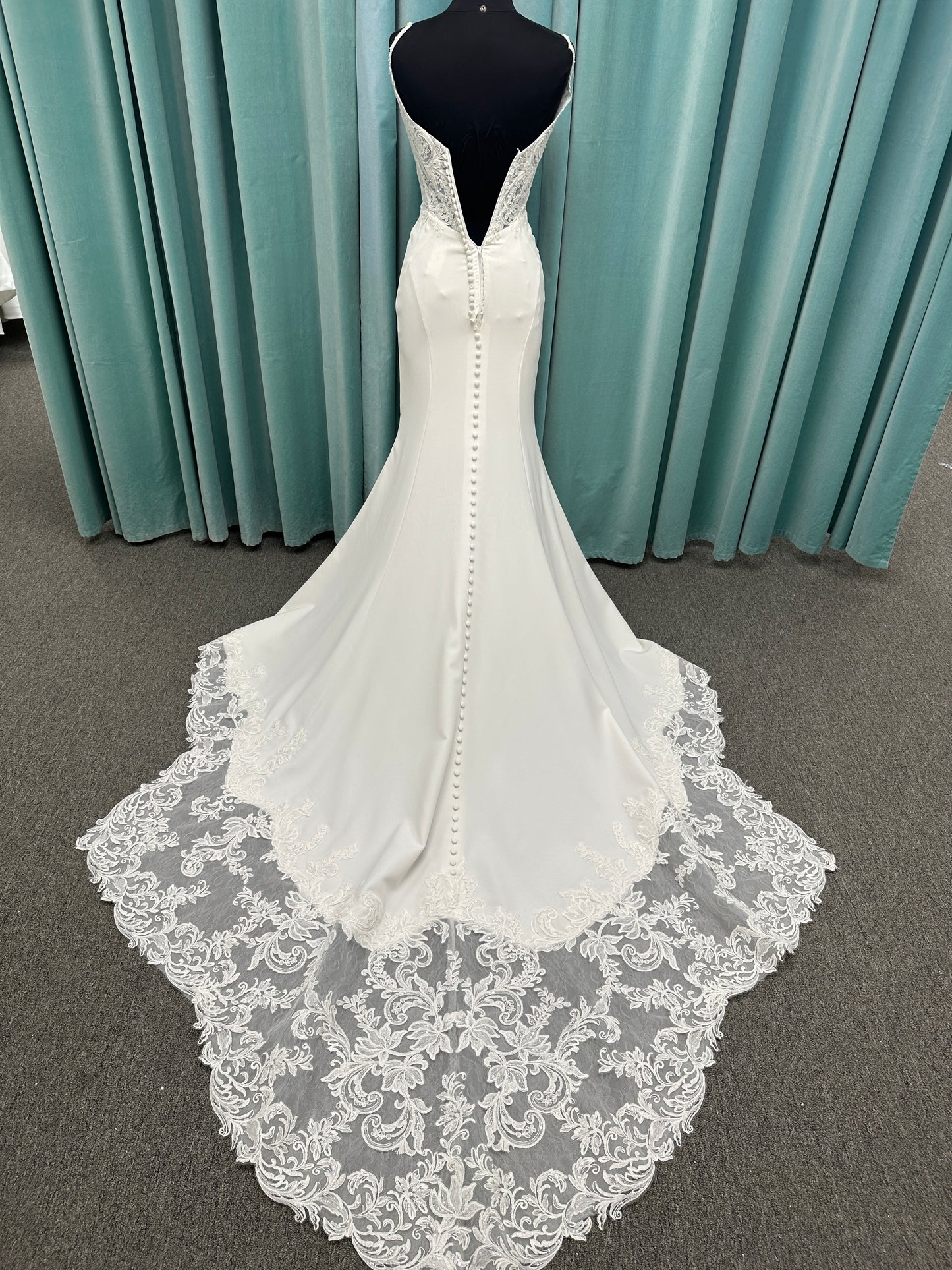 Essense of Australia D4181 column wedding dress with plunging V-neckline, pearl straps, lace bodice, and sleek crepe skirt with lace train