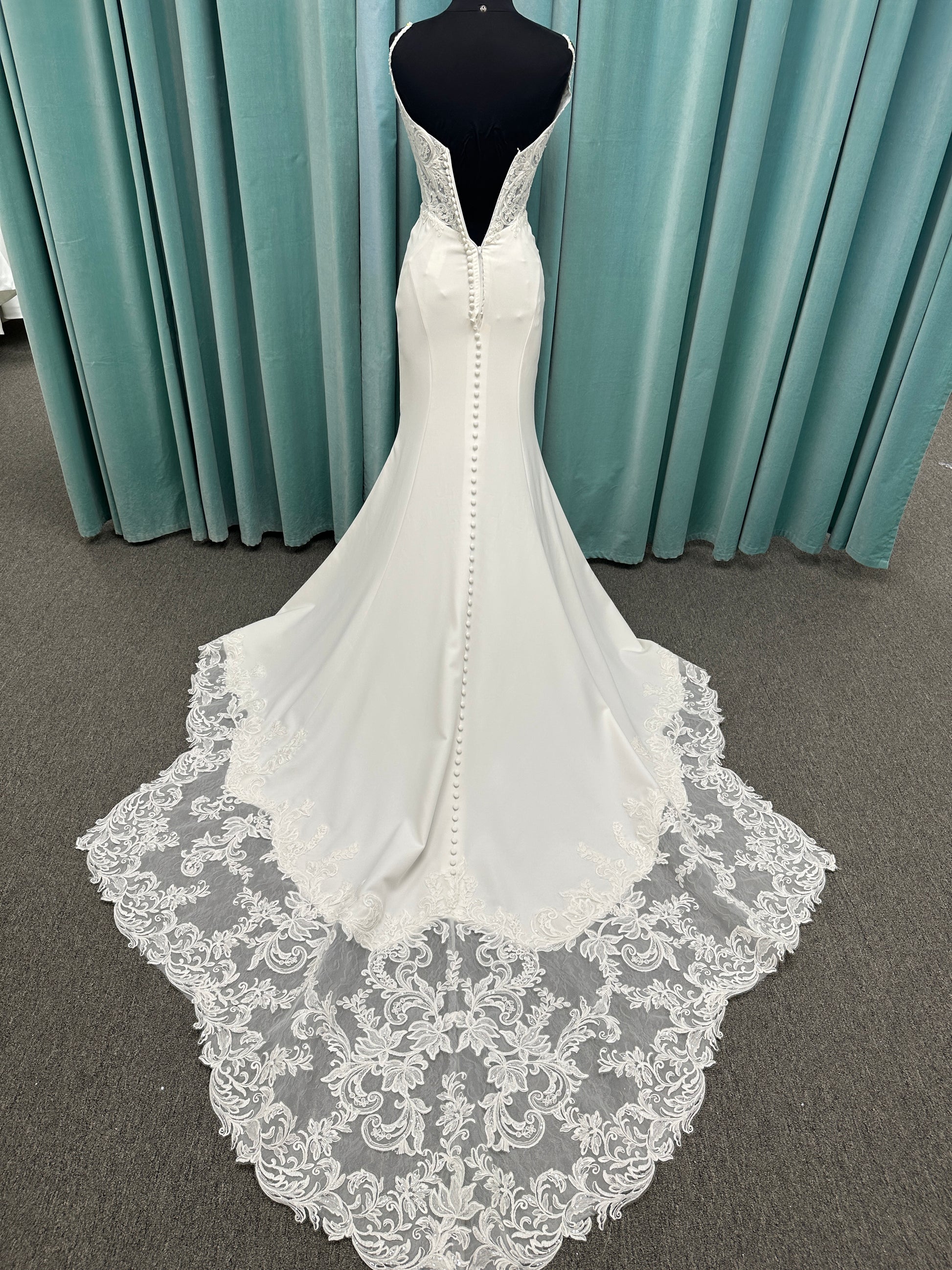 Essense of Australia D4181 column wedding dress with plunging V-neckline, pearl straps, lace bodice, and sleek crepe skirt with lace train