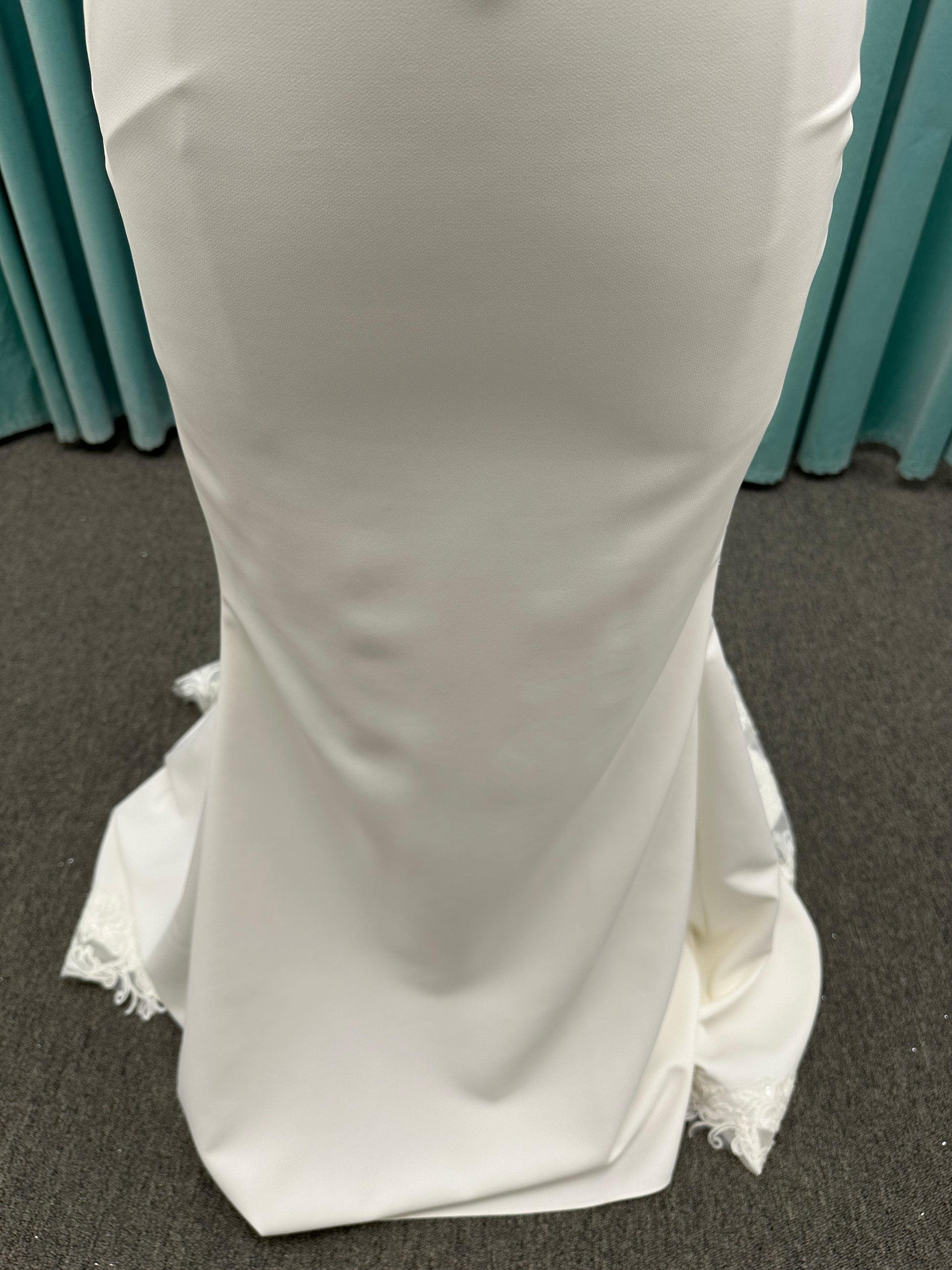 Essense of Australia D4181 column wedding dress with plunging V-neckline, pearl straps, lace bodice, and sleek crepe skirt with lace train