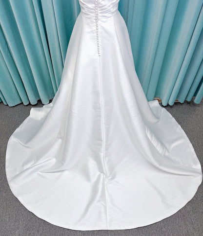 Morilee 1010001 Dove ballgown wedding dress on mannequin with strapless scoop neckline, lace peek-a-boo detail, and softly pleated skirt