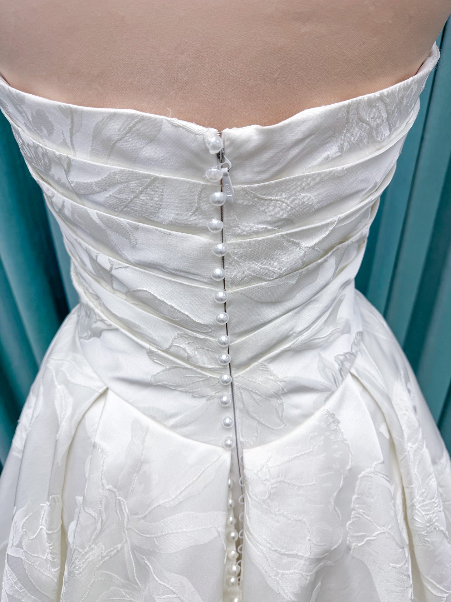 Strapless floral jacquard ballgown wedding dress with a sweetheart neckline, ruched bodice, defined waist, and full structured skirt.