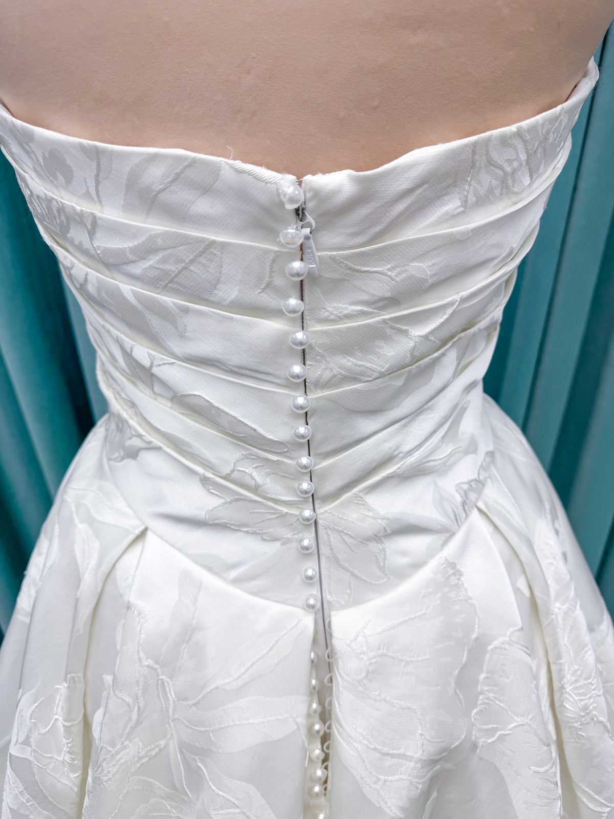 Strapless floral jacquard ballgown wedding dress with a sweetheart neckline, ruched bodice, defined waist, and full structured skirt.