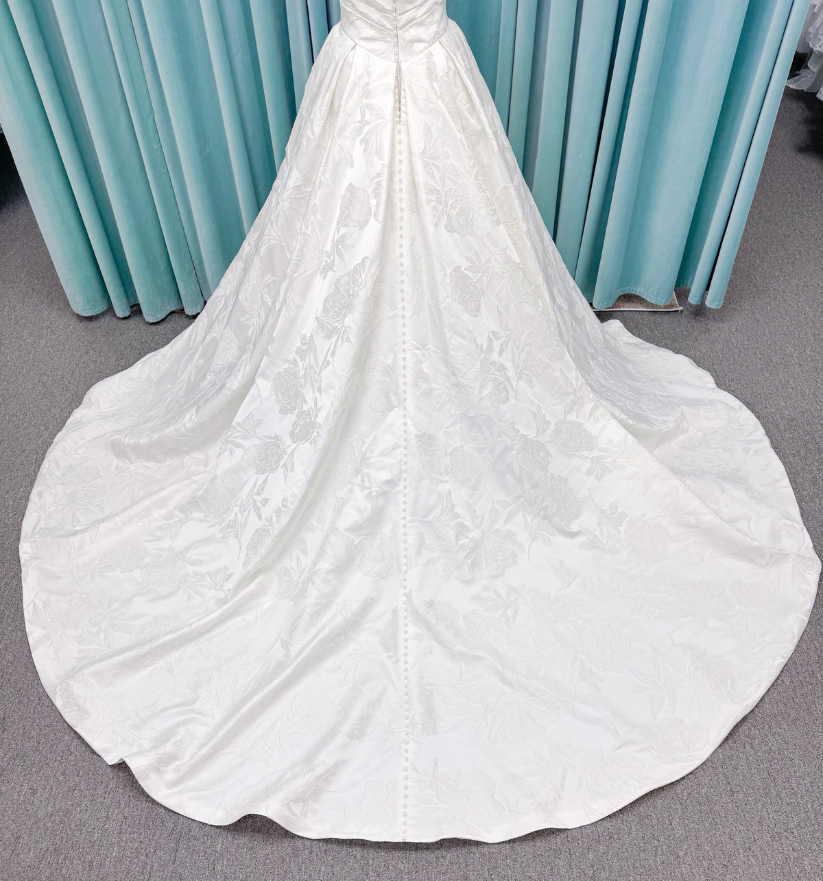 Strapless floral jacquard ballgown wedding dress with a sweetheart neckline, ruched bodice, defined waist, and full structured skirt.