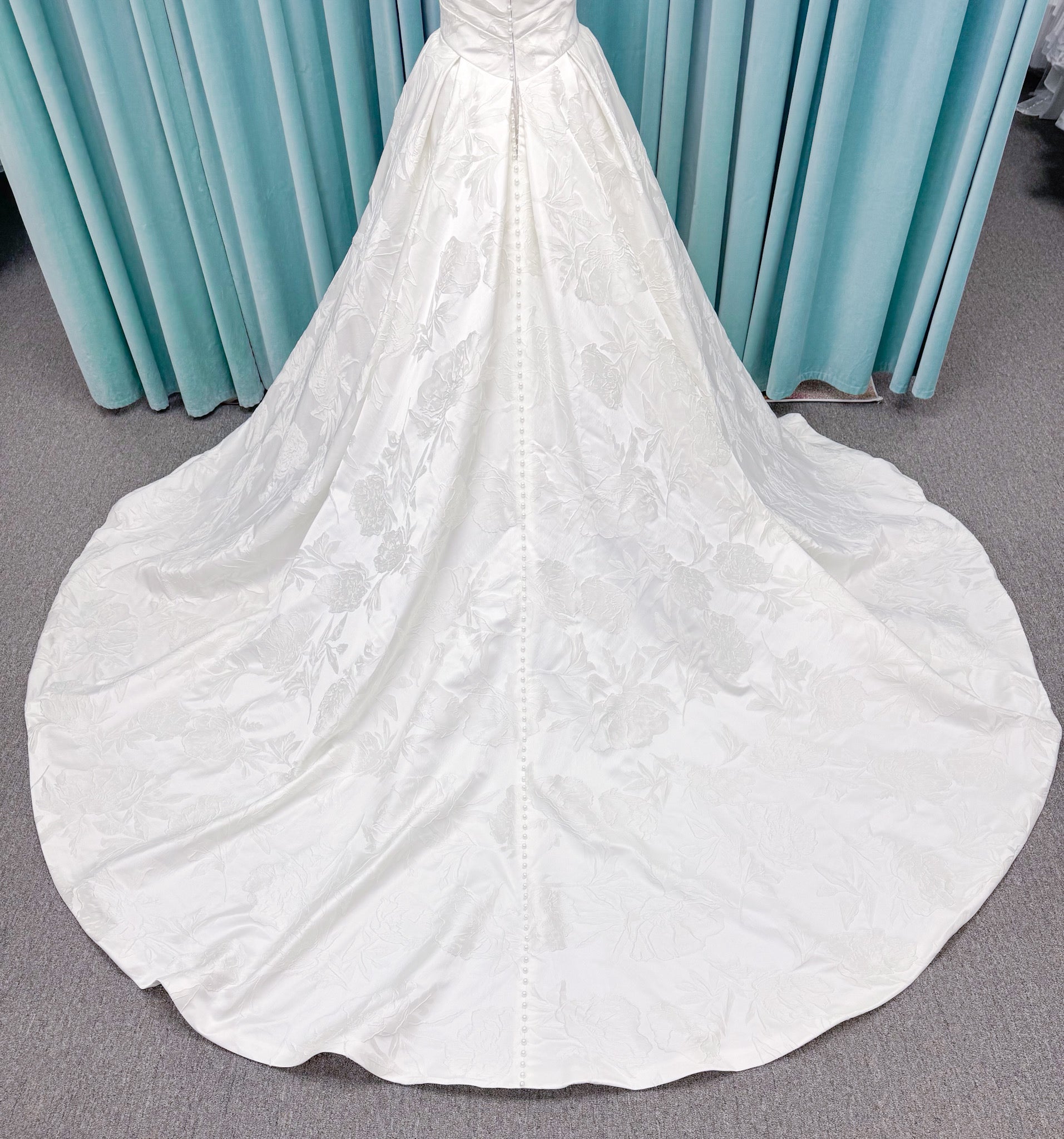 Strapless floral jacquard ballgown wedding dress with a sweetheart neckline, ruched bodice, defined waist, and full structured skirt.