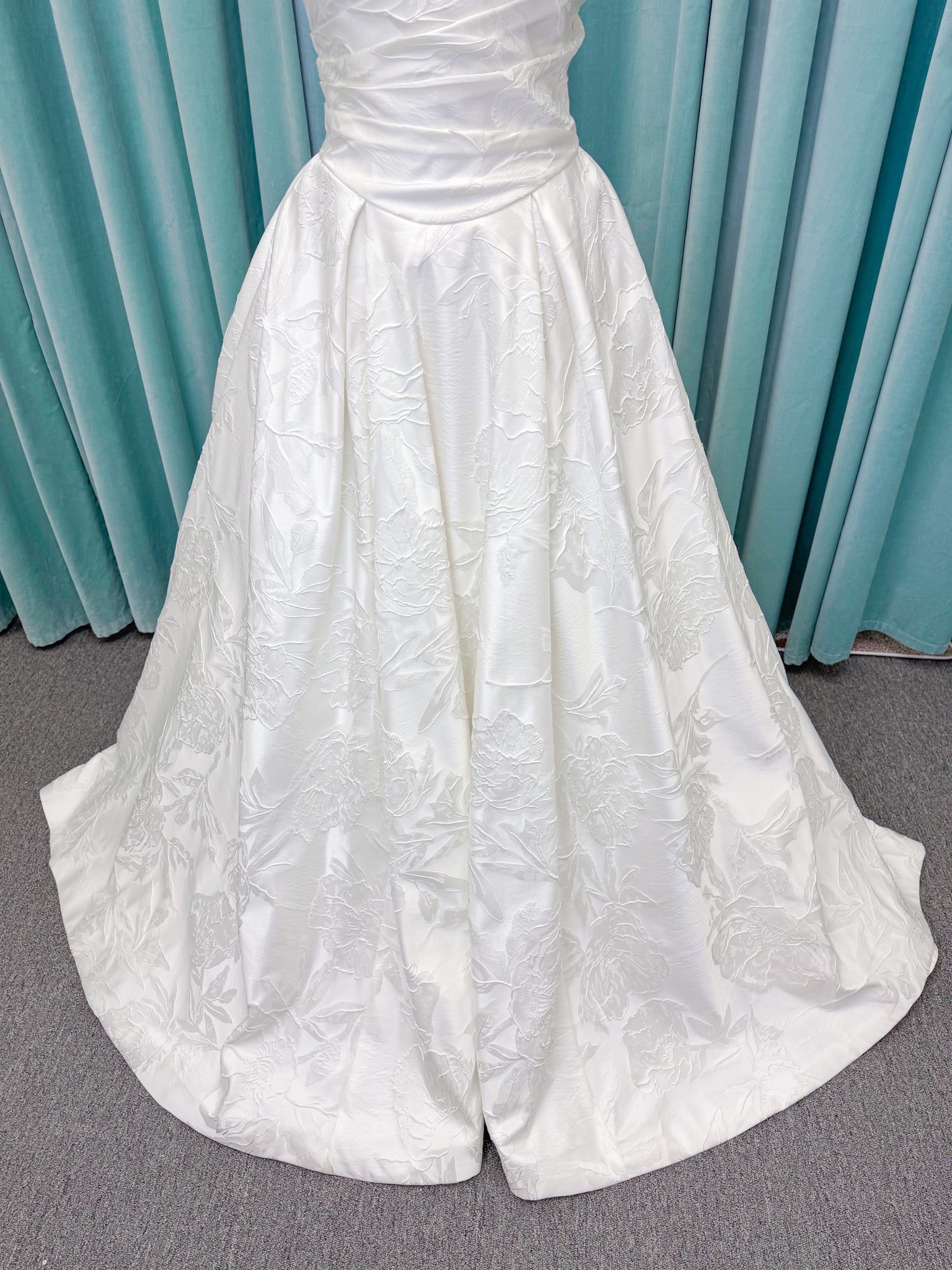 Strapless floral jacquard ballgown wedding dress with a sweetheart neckline, ruched bodice, defined waist, and full structured skirt.