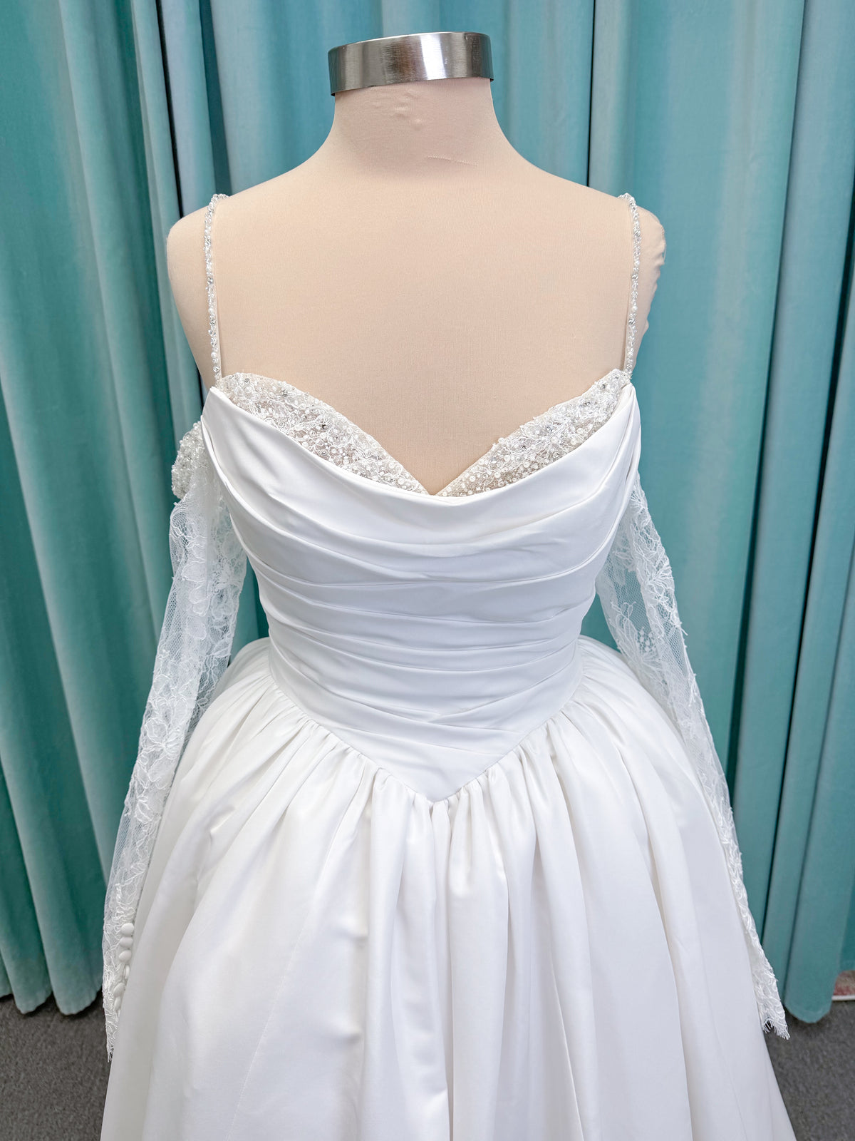 Morilee 1010003 Eleve A-line wedding dress on mannequin with scoop neckline, Chantilly lace peek-a-boo detail, beaded straps, and lace-up corset back