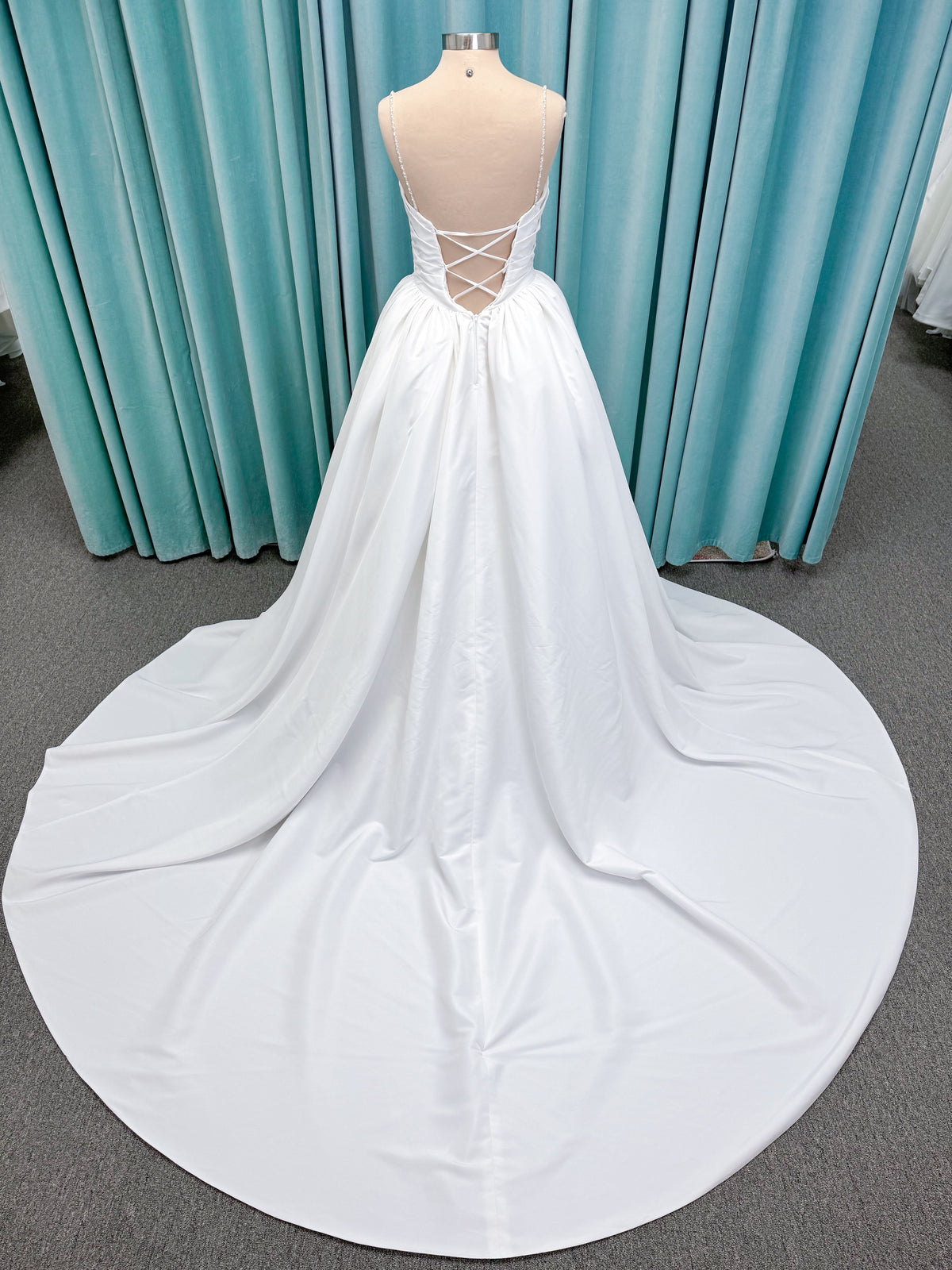 Morilee 1010003 Eleve A-line wedding dress on mannequin with scoop neckline, Chantilly lace peek-a-boo detail, beaded straps, and lace-up corset back