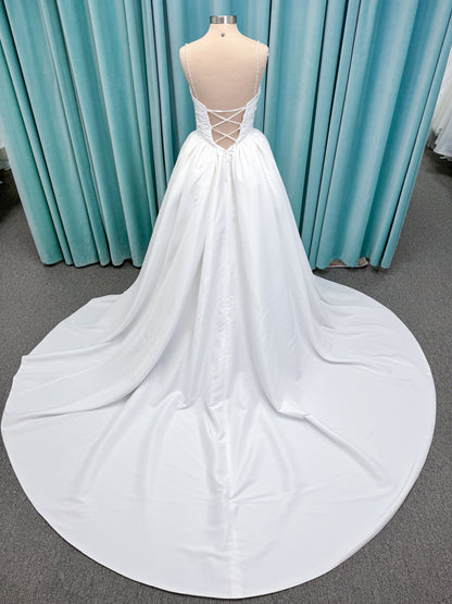 Morilee 1010003 Eleve A-line wedding dress on mannequin with scoop neckline, Chantilly lace peek-a-boo detail, beaded straps, and lace-up corset back