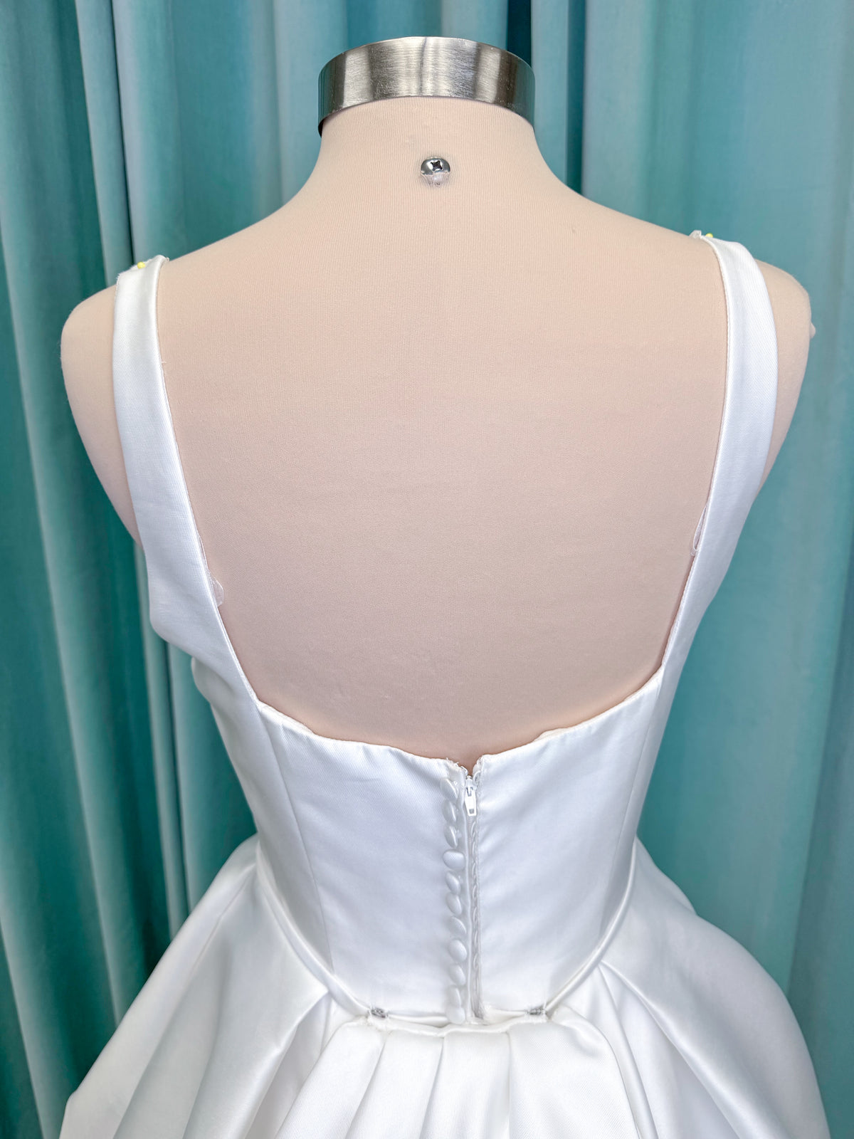 Morilee 2996 Eowyn A-line wedding dress on mannequin with square neckline, slender straps, Mikado fabric, and pockets