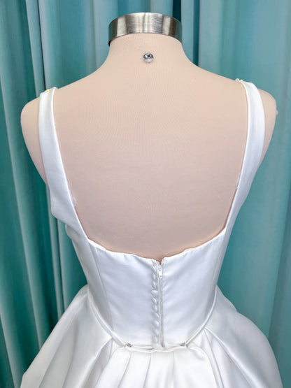 Morilee 2996 Eowyn A-line wedding dress on mannequin with square neckline, slender straps, Mikado fabric, and pockets