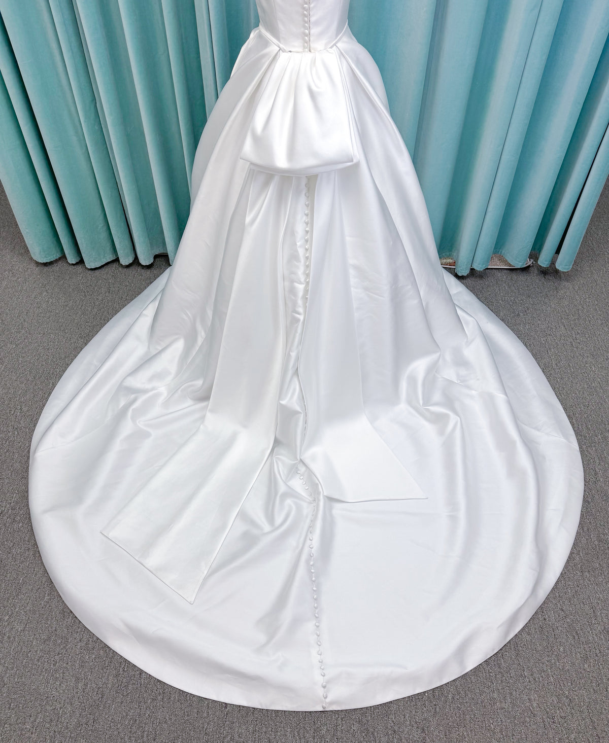 Morilee 2996 Eowyn A-line wedding dress on mannequin with square neckline, slender straps, Mikado fabric, and pockets