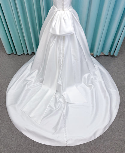Morilee 2996 Eowyn A-line wedding dress on mannequin with square neckline, slender straps, Mikado fabric, and pockets