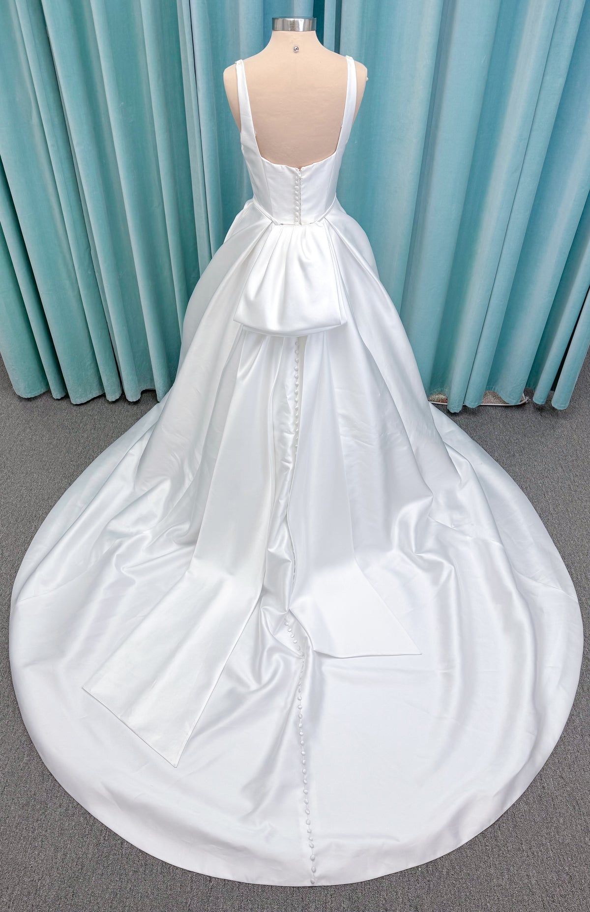 Morilee 2996 Eowyn A-line wedding dress on mannequin with square neckline, slender straps, Mikado fabric, and pockets