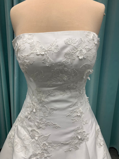 Strapless Mikado A-line wedding dress with straight neckline, lace detailing, and full skirt with hip volume by Essense of Australia Style D4479