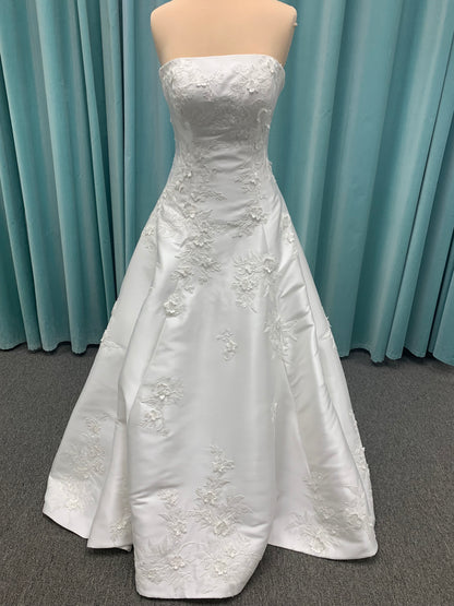 Strapless Mikado A-line wedding dress with straight neckline, lace detailing, and full skirt with hip volume by Essense of Australia Style D4479