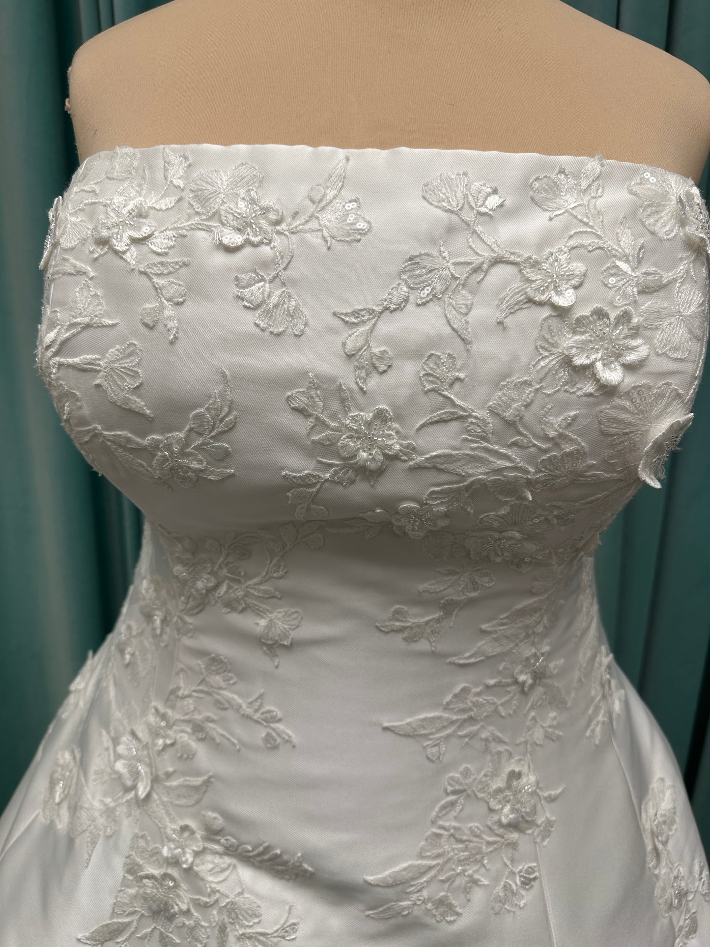 Plus Size Strapless Mikado A-line wedding dress with straight neckline, lace detailing, and full skirt with hip volume by Essense of Australia Style D4479