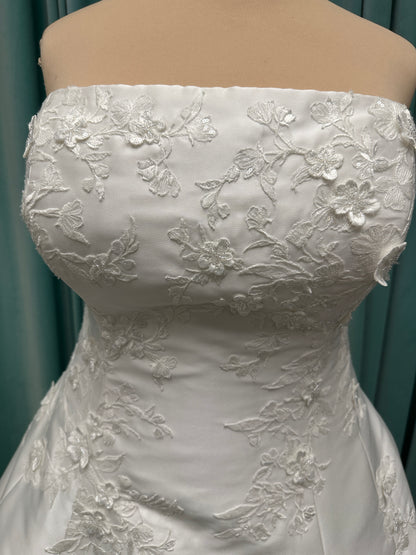 Plus Size Strapless Mikado A-line wedding dress with straight neckline, lace detailing, and full skirt with hip volume by Essense of Australia Style D4479