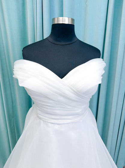 Morilee 3350 Evette ball gown wedding dress in draped organza with off-the-shoulder surplice bodice, horsehair-edged skirt, and covered buttons to hem.
