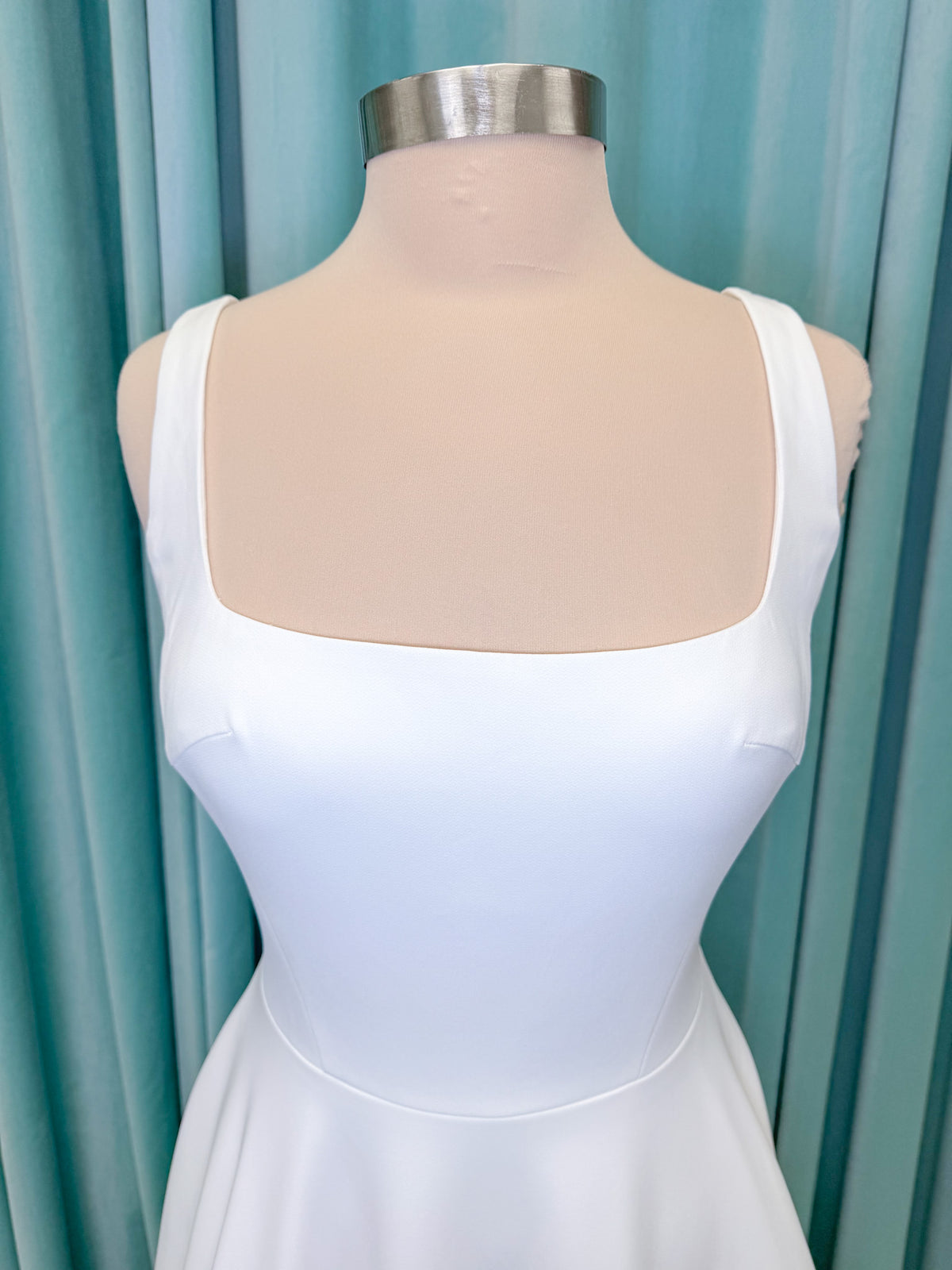 A-Line Ivory wedding dress on mannequin with square neckline and matte crepe A-line skirt