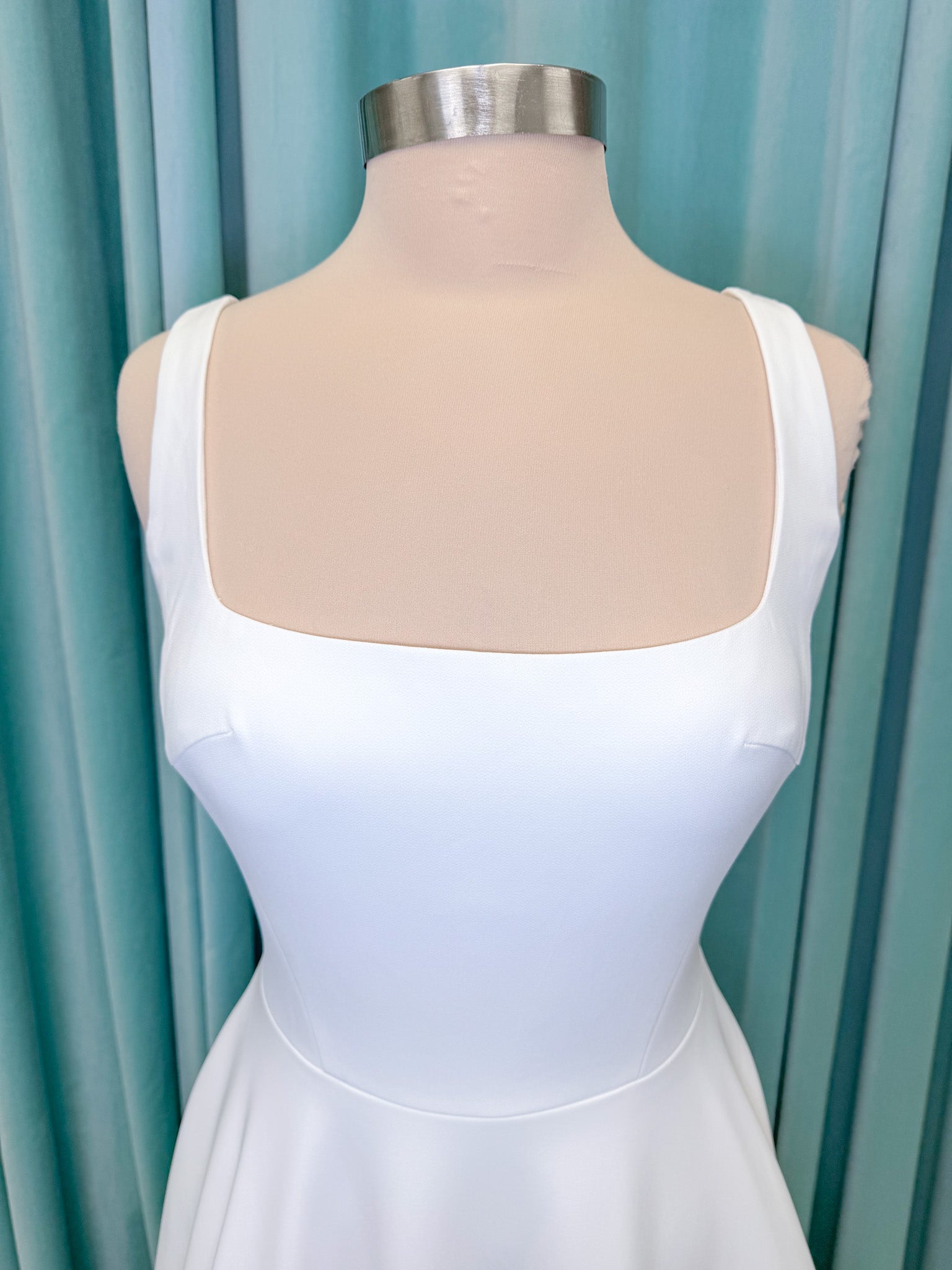 A-Line Ivory wedding dress on mannequin with square neckline and matte crepe A-line skirt