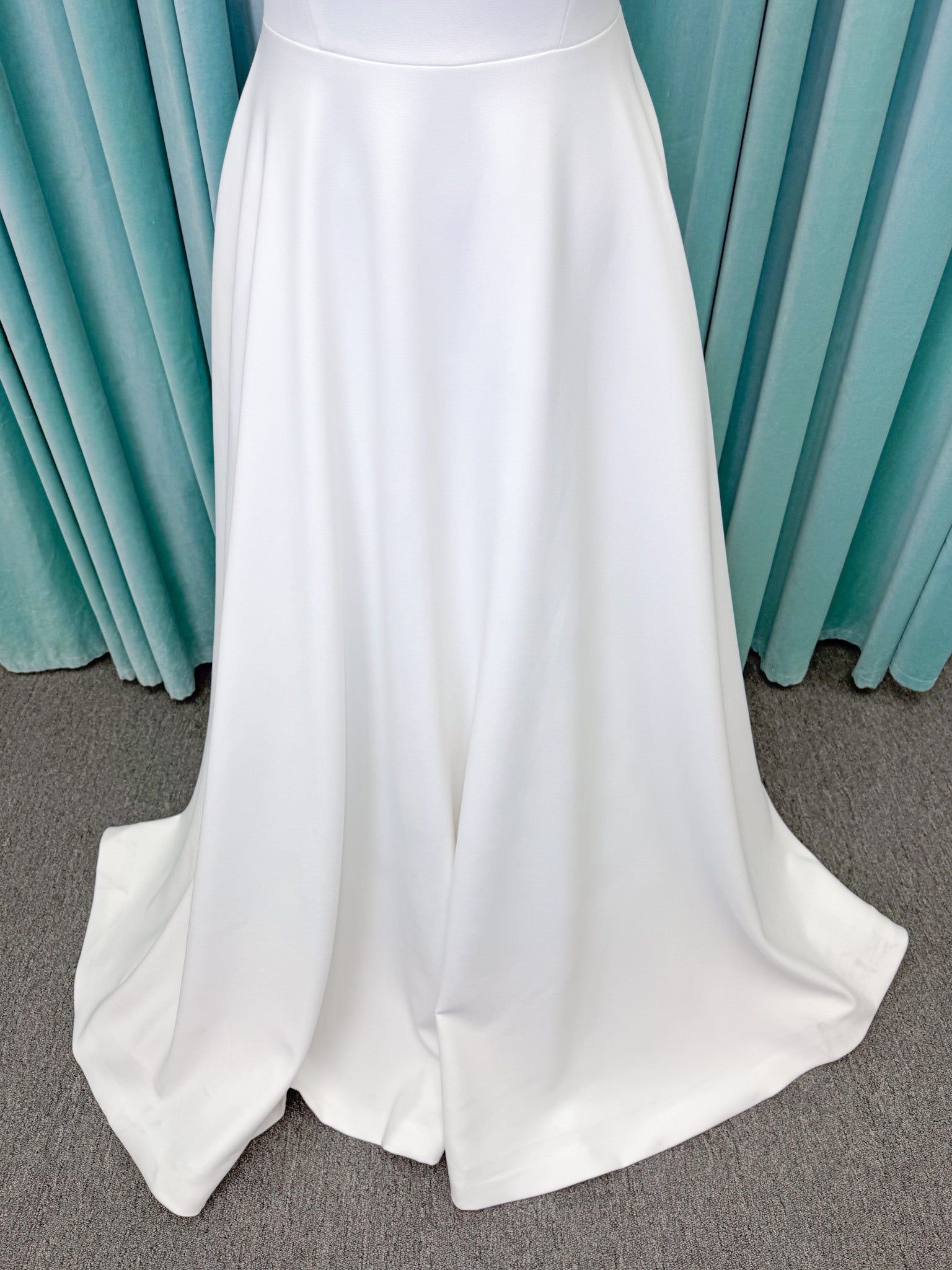 A-Line Ivory wedding dress on mannequin with square neckline and matte crepe A-line skirt