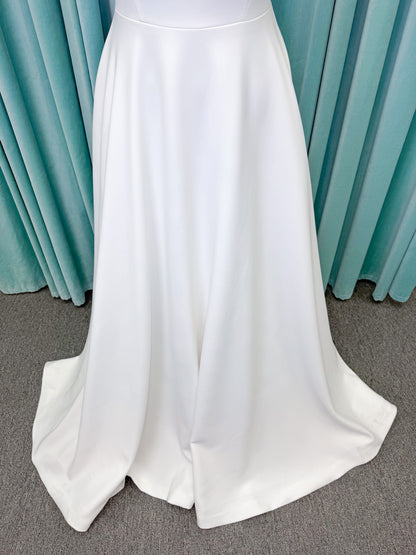 A-Line Ivory wedding dress on mannequin with square neckline and matte crepe A-line skirt