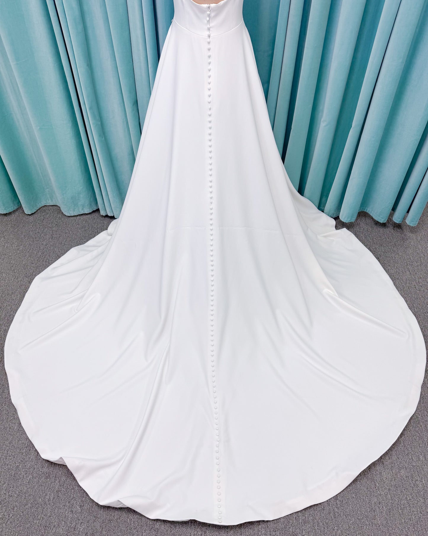 A-Line Ivory wedding dress on mannequin with square neckline and matte crepe A-line skirt