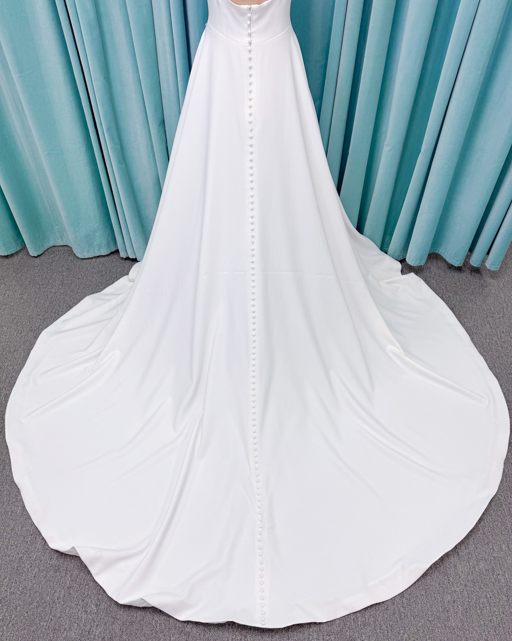A-Line Ivory wedding dress on mannequin with square neckline and matte crepe A-line skirt