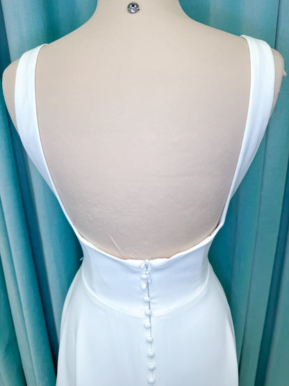 A-Line Ivory wedding dress on mannequin with square neckline and matte crepe A-line skirt