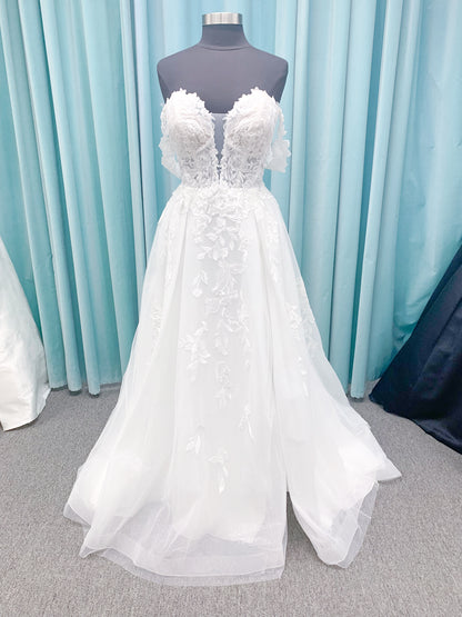 Morilee 2979 Filippa A-line wedding dress in glitter tulle with plunge sweetheart bodice, sequin beaded threadwork appliqués, detachable off-shoulder straps, and front slit.