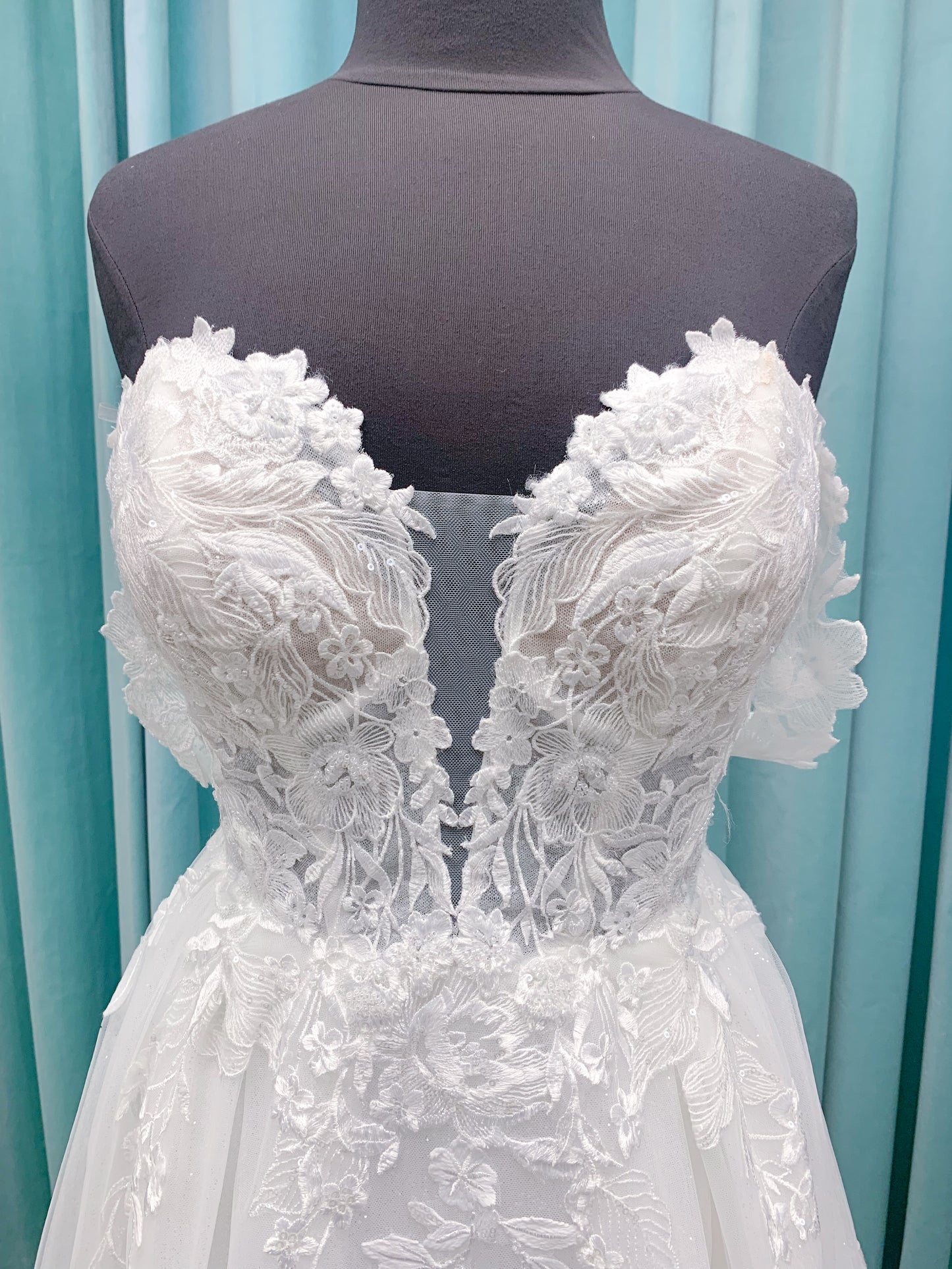 Morilee 2979 Filippa A-line wedding dress in glitter tulle with plunge sweetheart bodice, sequin beaded threadwork appliqués, detachable off-shoulder straps, and front slit.