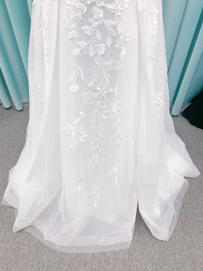 Morilee 2979 Filippa A-line wedding dress in glitter tulle with plunge sweetheart bodice, sequin beaded threadwork appliqués, detachable off-shoulder straps, and front slit.