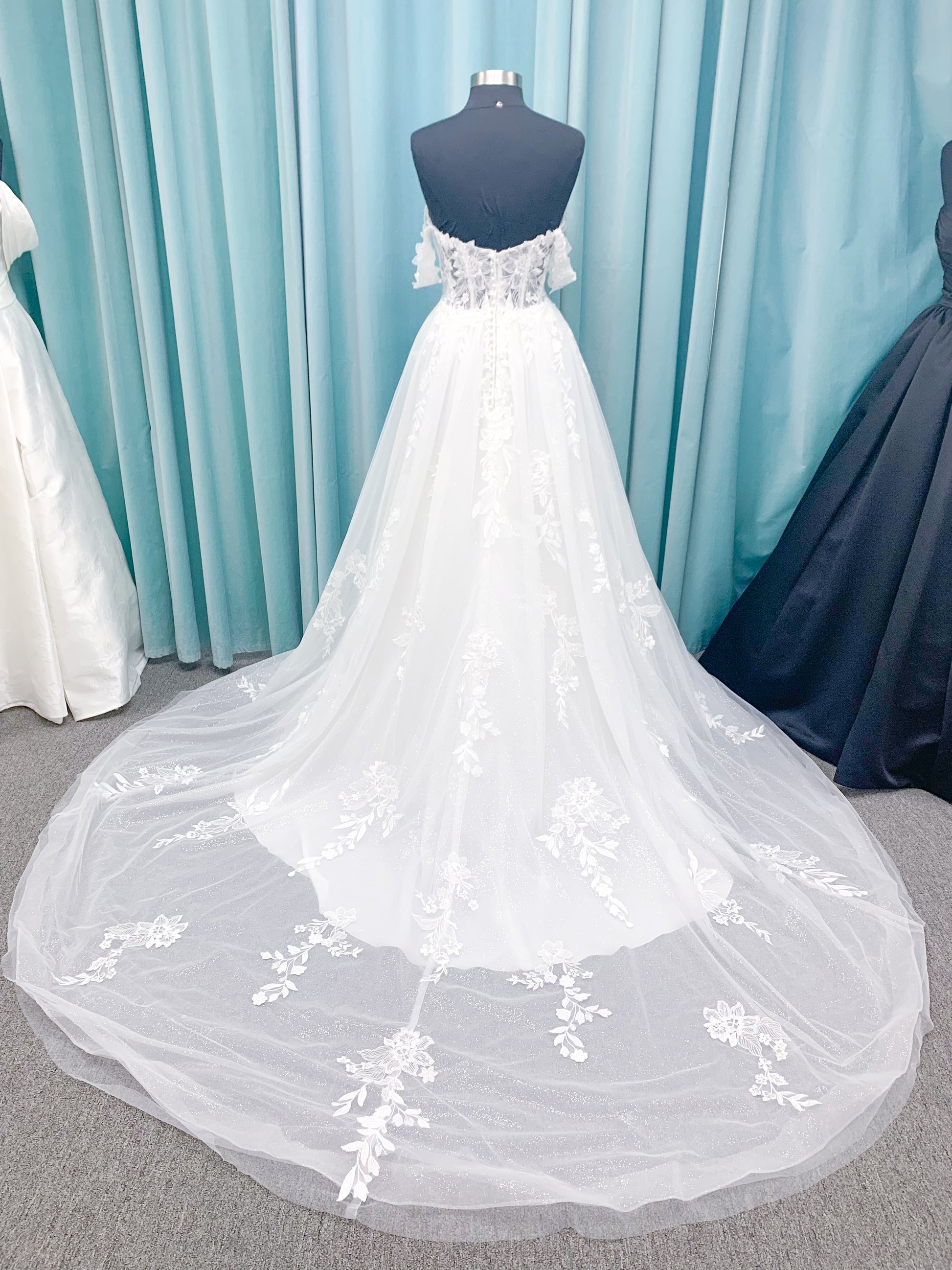 Morilee 2979 Filippa A-line wedding dress in glitter tulle with plunge sweetheart bodice, sequin beaded threadwork appliqués, detachable off-shoulder straps, and front slit.