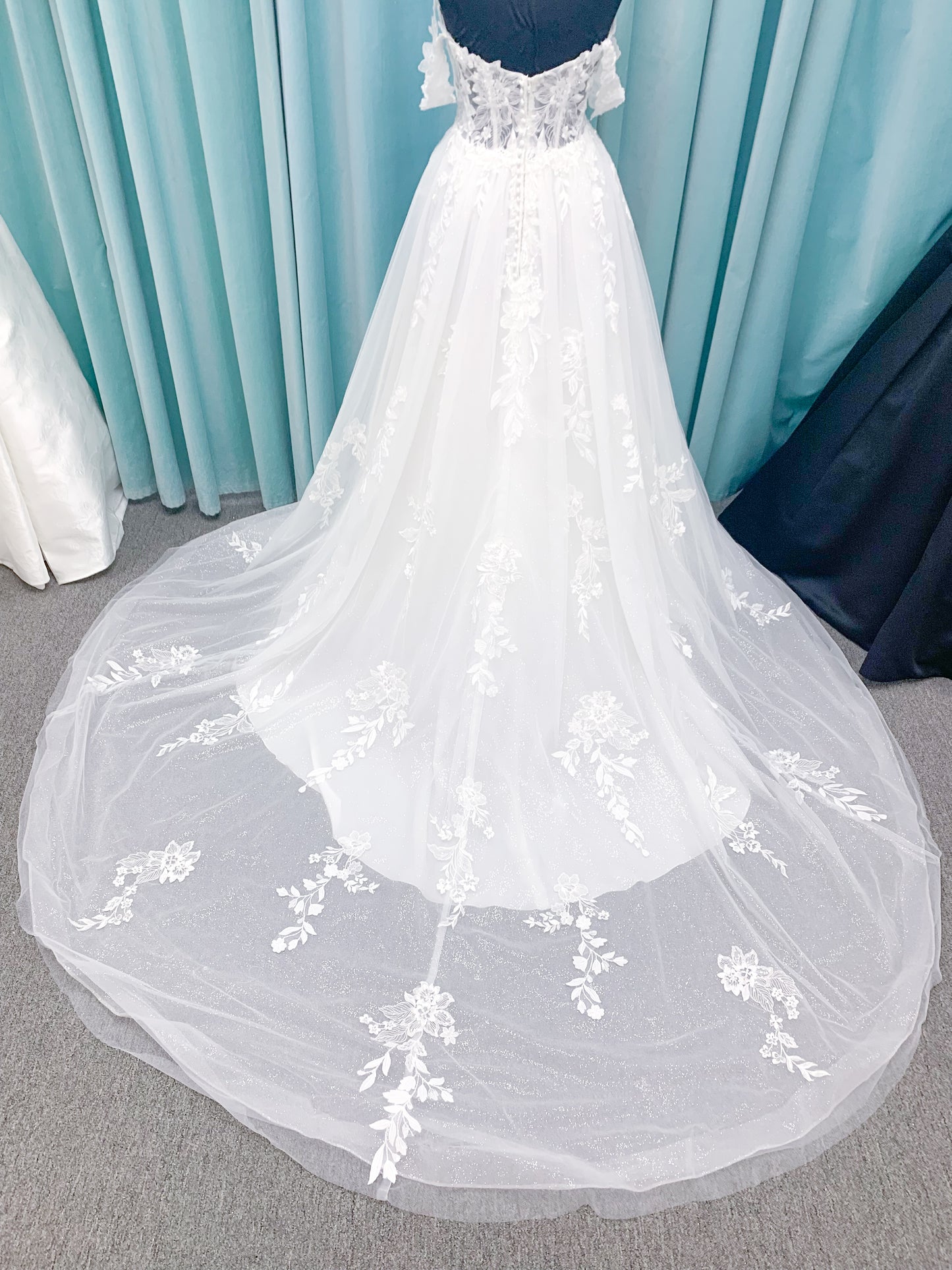 Morilee 2979 Filippa A-line wedding dress in glitter tulle with plunge sweetheart bodice, sequin beaded threadwork appliqués, detachable off-shoulder straps, and front slit.