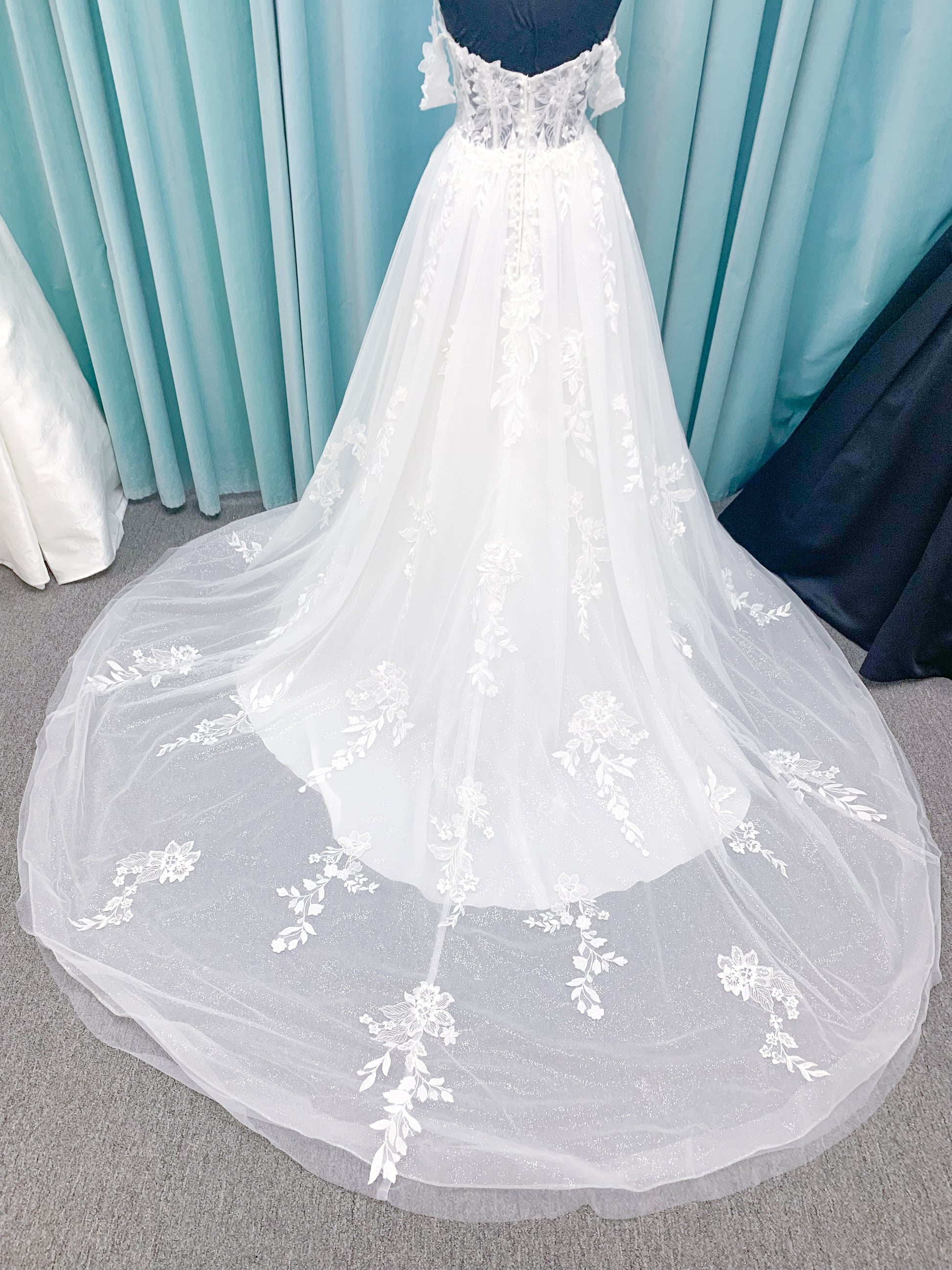 Morilee 2979 Filippa A-line wedding dress in glitter tulle with plunge sweetheart bodice, sequin beaded threadwork appliqués, detachable off-shoulder straps, and front slit.