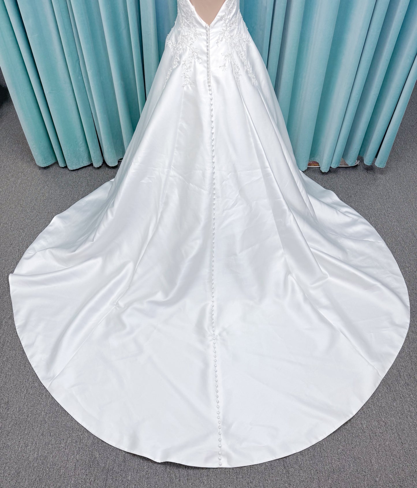 Morilee 1050018 Glissade A-line wedding dress on mannequin with high neckline, 3D floral lace appliques, satin, and beading
