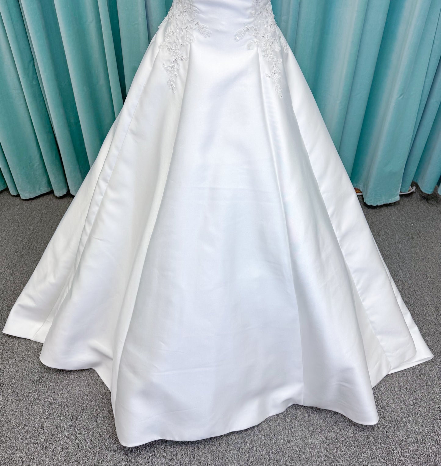 Morilee 1050018 Glissade A-line wedding dress on mannequin with high neckline, 3D floral lace appliques, satin, and beading