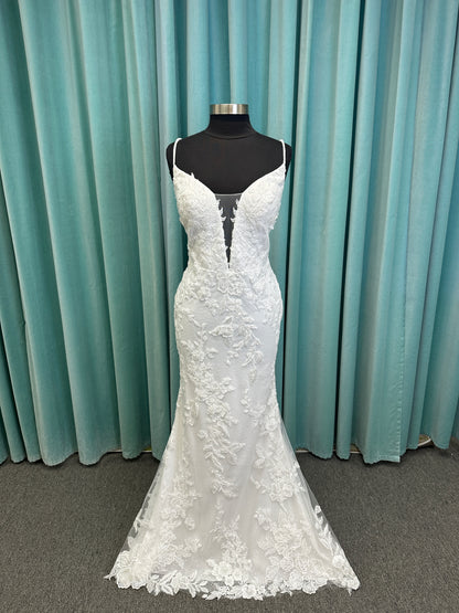 Gracie ivory long sleeve V-neck fit-and-flare wedding dress on mannequin with illusion lace sleeves, fitted silhouette, and scalloped lace cathedral train.
