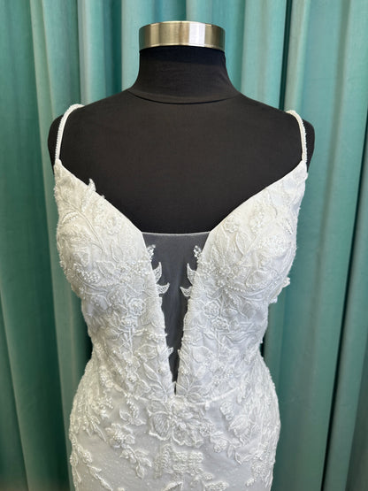 Gracie ivory long sleeve V-neck fit-and-flare wedding dress on mannequin with illusion lace sleeves, fitted silhouette, and scalloped lace cathedral train.
