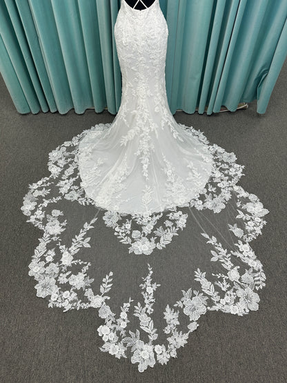 Gracie ivory long sleeve V-neck fit-and-flare wedding dress on mannequin with illusion lace sleeves, fitted silhouette, and scalloped lace cathedral train.
