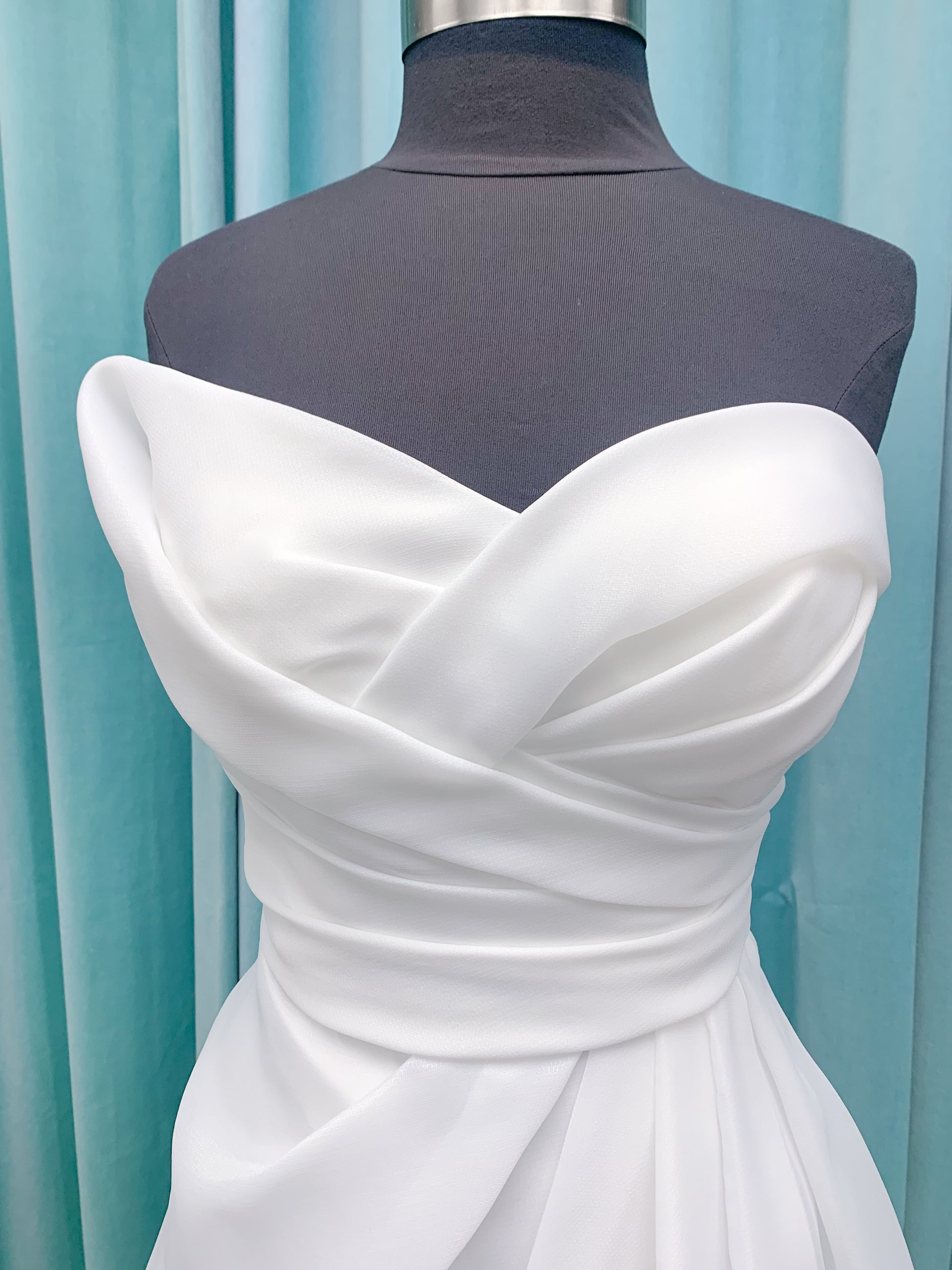 Morilee 2989 Helenia contemporary strapless A-line wedding dress in draped organza with detachable bow and sweeping train.