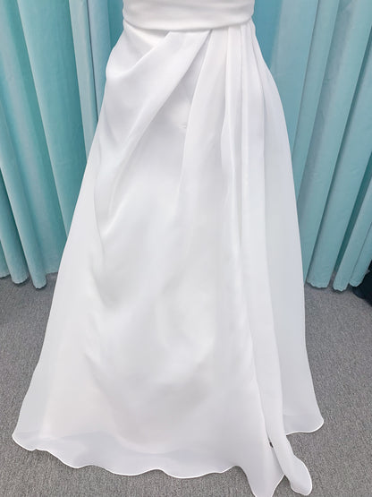 Morilee 2989 Helenia contemporary strapless A-line wedding dress in draped organza with detachable bow and sweeping train.