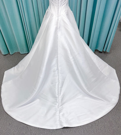 Randy Fenoli Idonna ball gown wedding dress on mannequin with strapless sweetheart neckline, structured mikado bodice, basque waist, covered back buttons, and side pockets