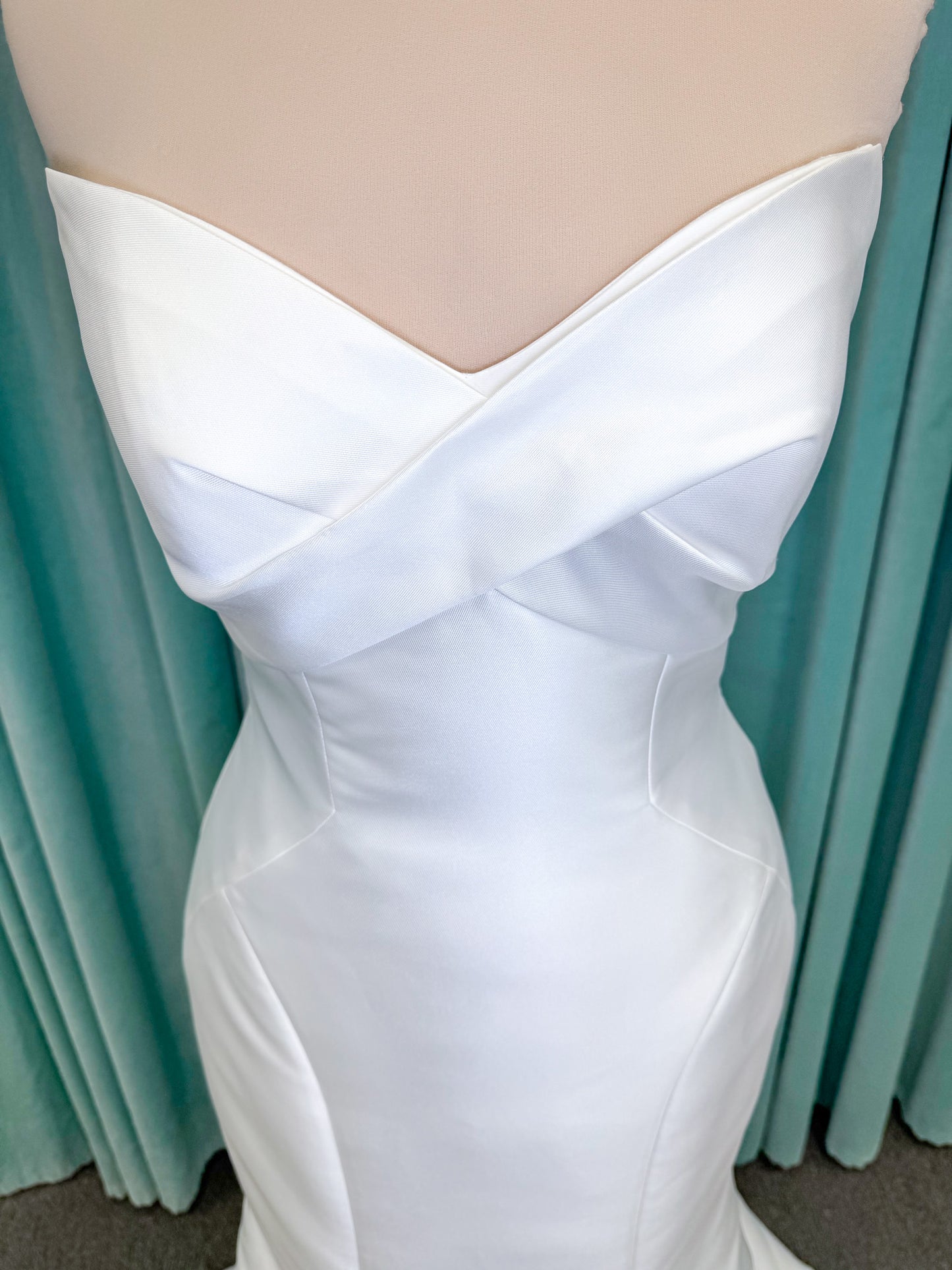 Randy Fenoli Imani fit and flare wedding dress on mannequin with strapless sweetheart neckline, structured mikado bodice, and oversized back bow with covered buttons